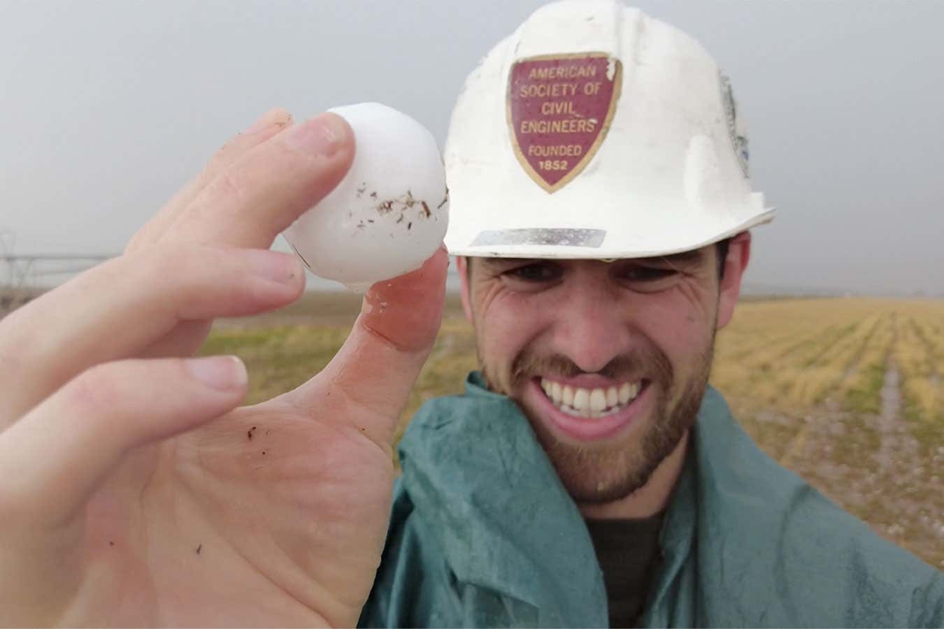 James Dinneen holds a large hail stone from this year's ICECHIP research