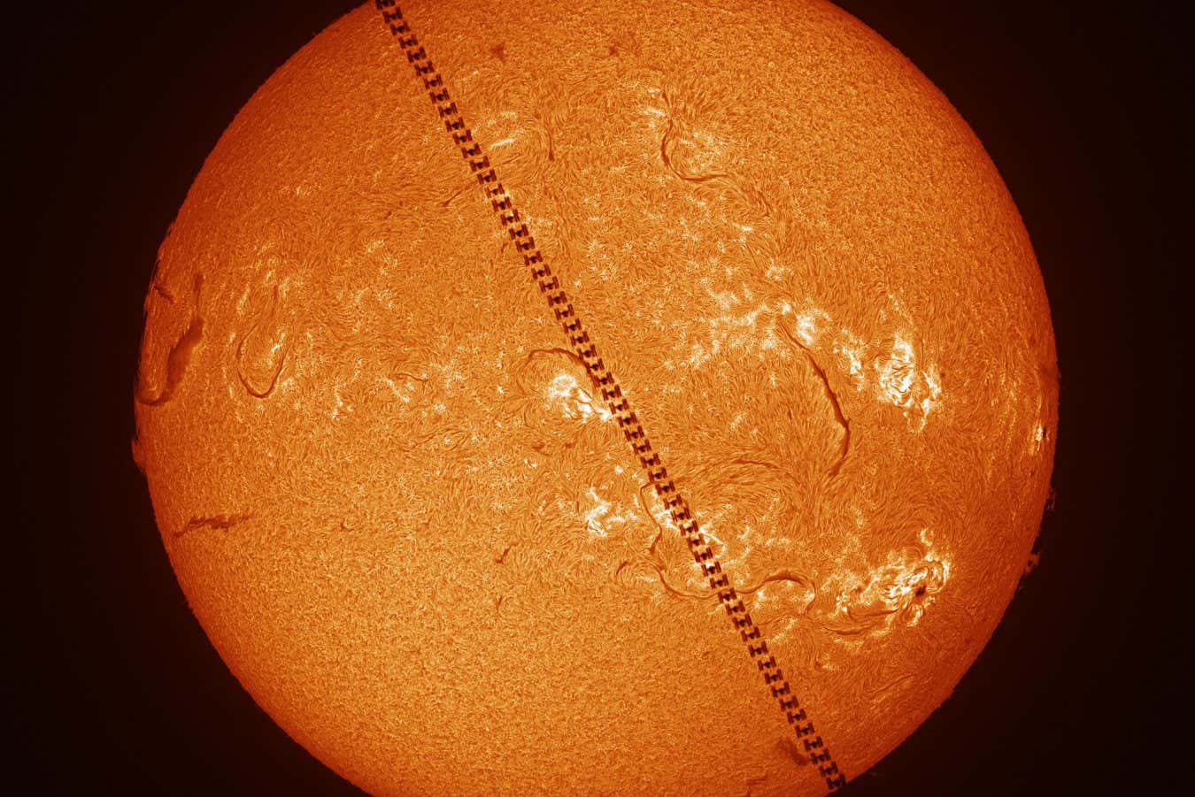 Encounter Within One Second ? Zhang Yanguang This image captures the International Space Station (ISS) transiting across the solar disc. The solar background was captured separately with double-stacked etalon[an optical filter that isolates specific wavelengths, used to observe solar details], and reveals high-contrast chromospheric details. The imaging sequences were strategically combined during post-processing to preserve both the spacecraft?s crisp silhouette and the Sun?s intricate surface features. Taken with a Takahashi Teegul 60 telescope, Coronado SolarMax 60 double stacked, Vixen polaris mount, Player One Astronomy Neptune-M camera, 500 mm f/8.3, 0.3-millisecond exposure Location: Xiamen, Fujian, China, 24 January 2025
