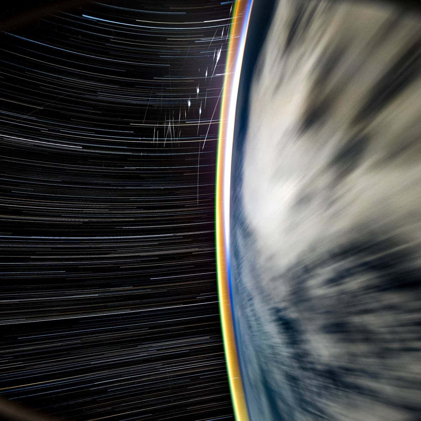 High resolution star trail from the SpaceX Crew 9 Dragon, marked by a fleet of flashing Starlink satellites, glowing atmosphere, soon to rise sun, and arcing stars. Captured over the Pacific Ocean with Nikon Z9, Sigma 14mm f1.4 lens, effective 24 minute exposure compiled from individual 30 second frames, f1.4, ISO 1600.